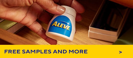 hand holding Aleve® bottle
