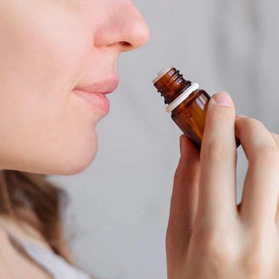 Person smelling essential oil
