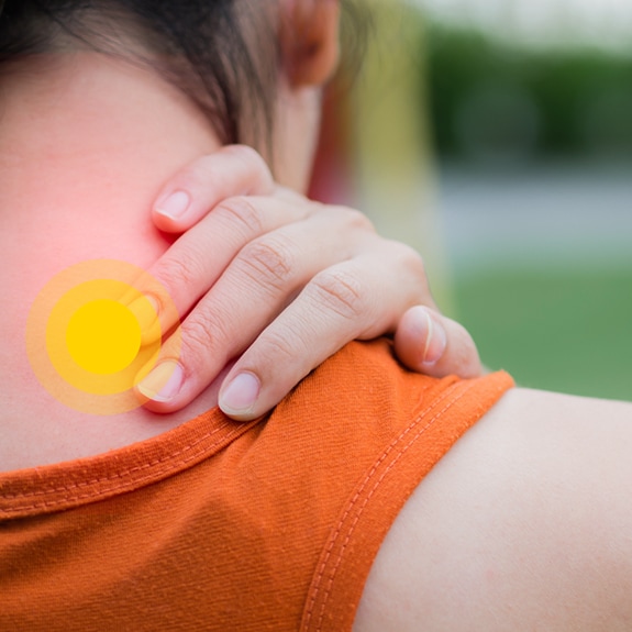 Person with upper back pain and yellow circle on upper back