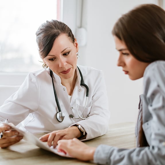Doctor and patient looking at paper