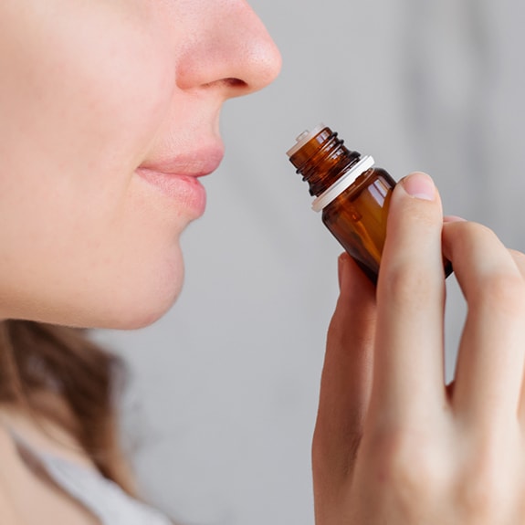 Person smelling essential oil